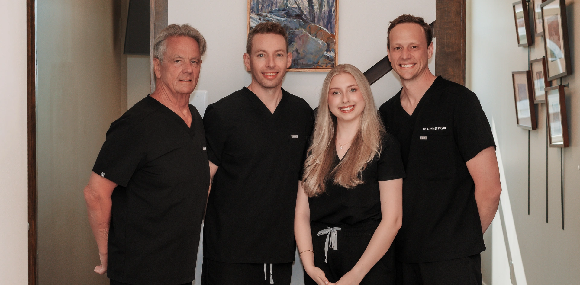 Dr. Drewyer's dental team of four professionals in black scrubs at Burtonsville practice.