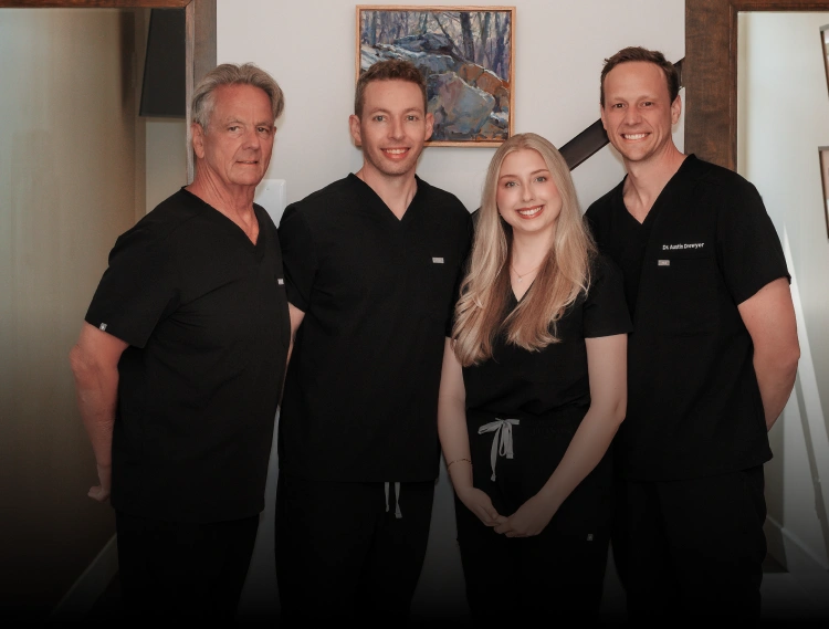 Drewyer Dentistry team of four dental professionals in black scrubs at Burtonsville practice.